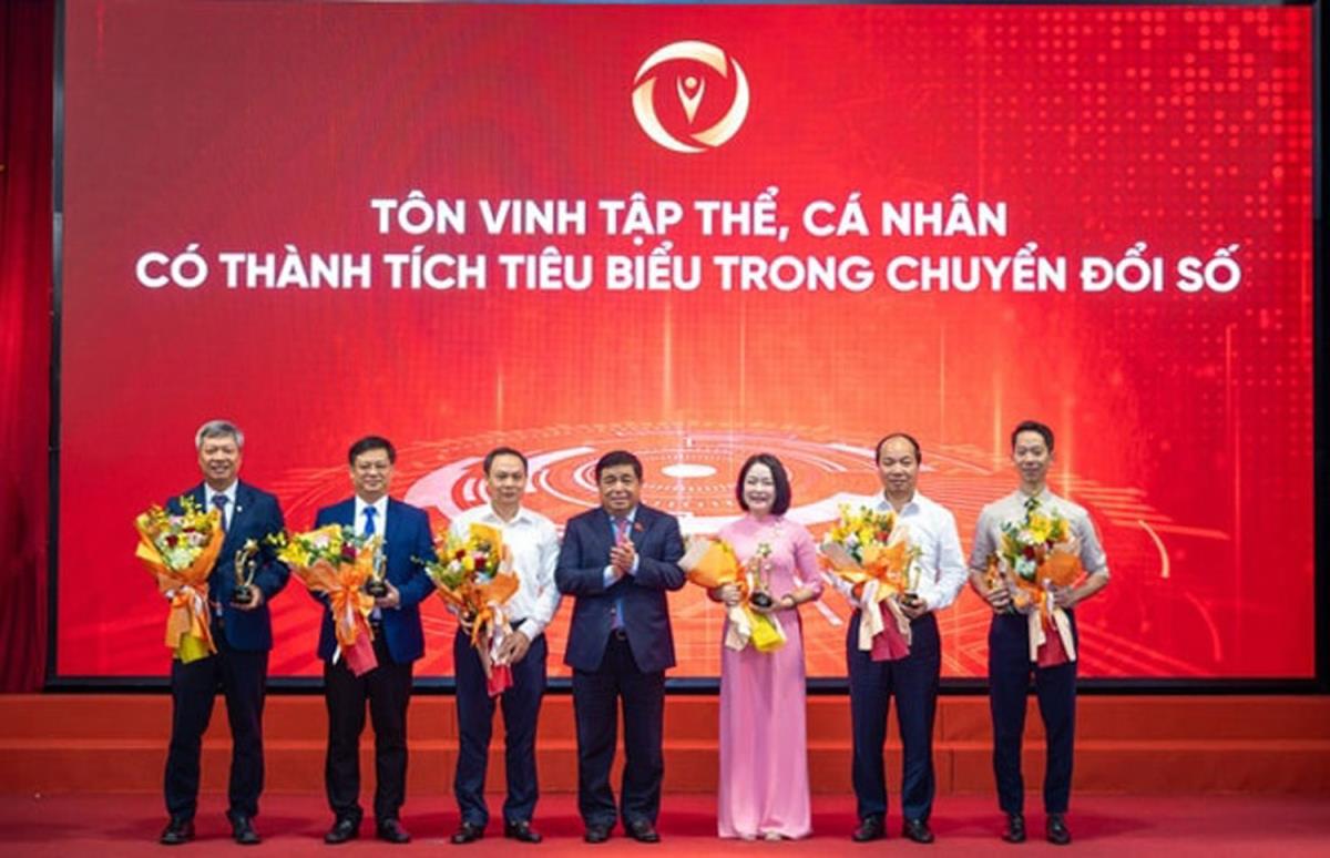 Phó Chủ tịch UBND TP. Đà Nẵng Hồ Quang Bửu (ngoài cùng, bên trái) đại diện thành phố nhận hoa và tặng thưởng từ Phó Thủ tướng Chính phủ Nguyễn Chí Dũng