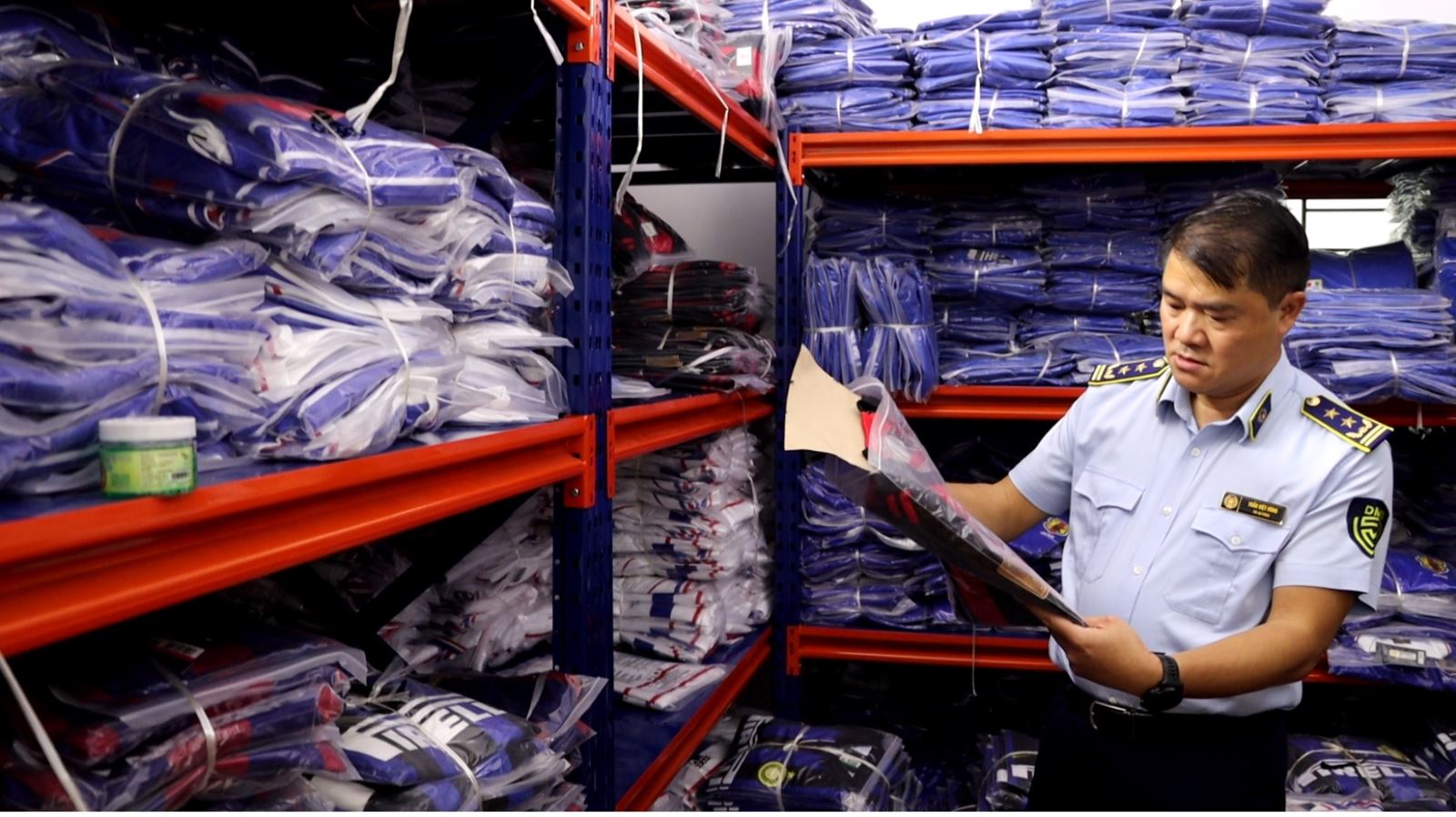 Lực lượng chức năng kiểm tra tại cơ sở kinh doanh quần áo thể thao trên phố Hoàng Công Chất, phường Phú Diễn, Hà Nội.